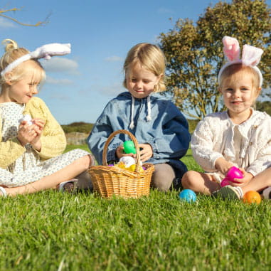 Kids with easter bunny ears and chocolate eggs