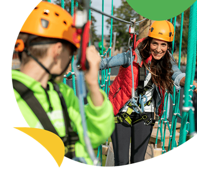A family climbing the high ropes course