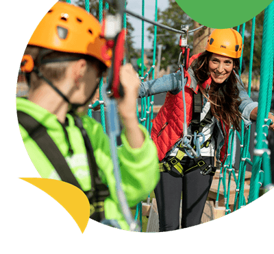 A family climbing the high ropes course
