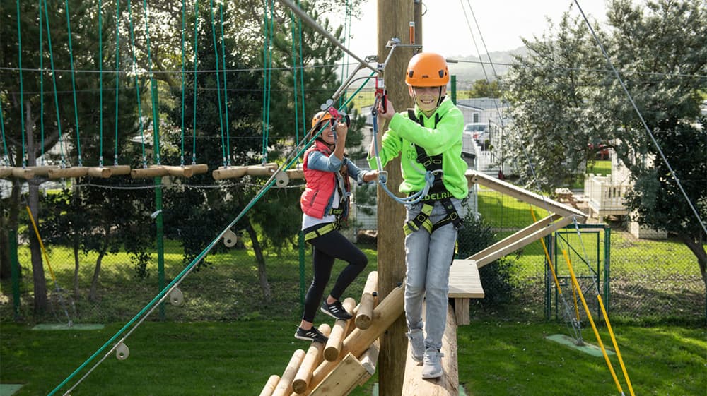 A boy balancing on the high ropes course at Ty Mawr Holiday Park