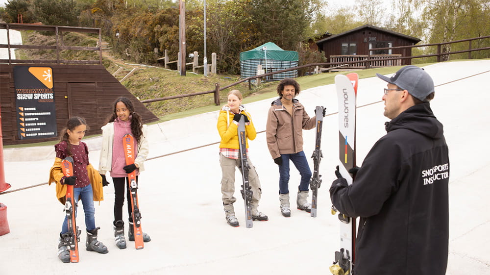 A family taking a skiing lesson at Warmwell Holiday Park
