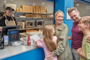 Family stood at Fish and Chippery at Parkdean Resorts