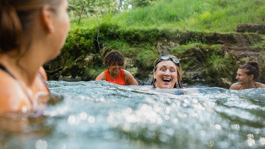 Women swimming in a river in the Lake District