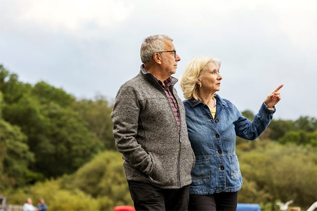 An older couple sightseeing in the countryside