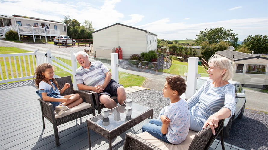 Grandparents and grandchildren relaxing on the veranda of a lodge