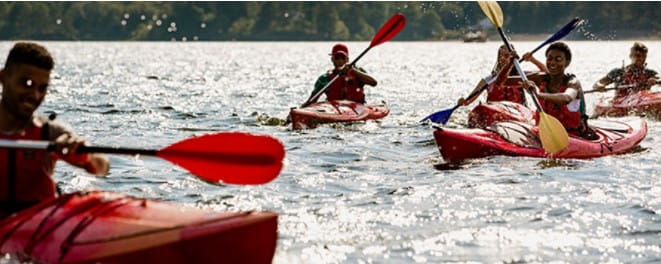 Young people kayaking on a lake