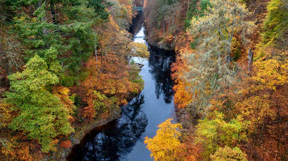 The River Tummel winding through the woodland near Pitlochry on an autumn day