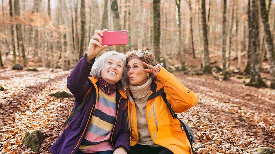 Two women posing for a selfie on an autumn walk