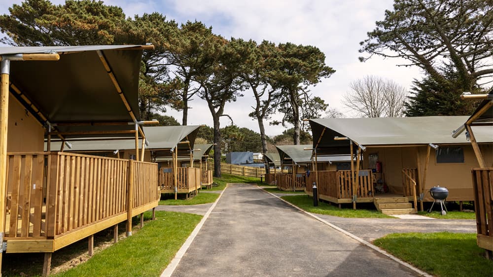 A row of safari glamping tents at Newquay Holiday Park in Cornwall