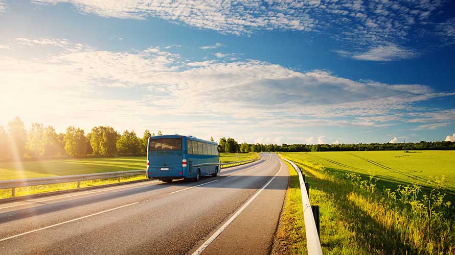 A bus driving down a country road
