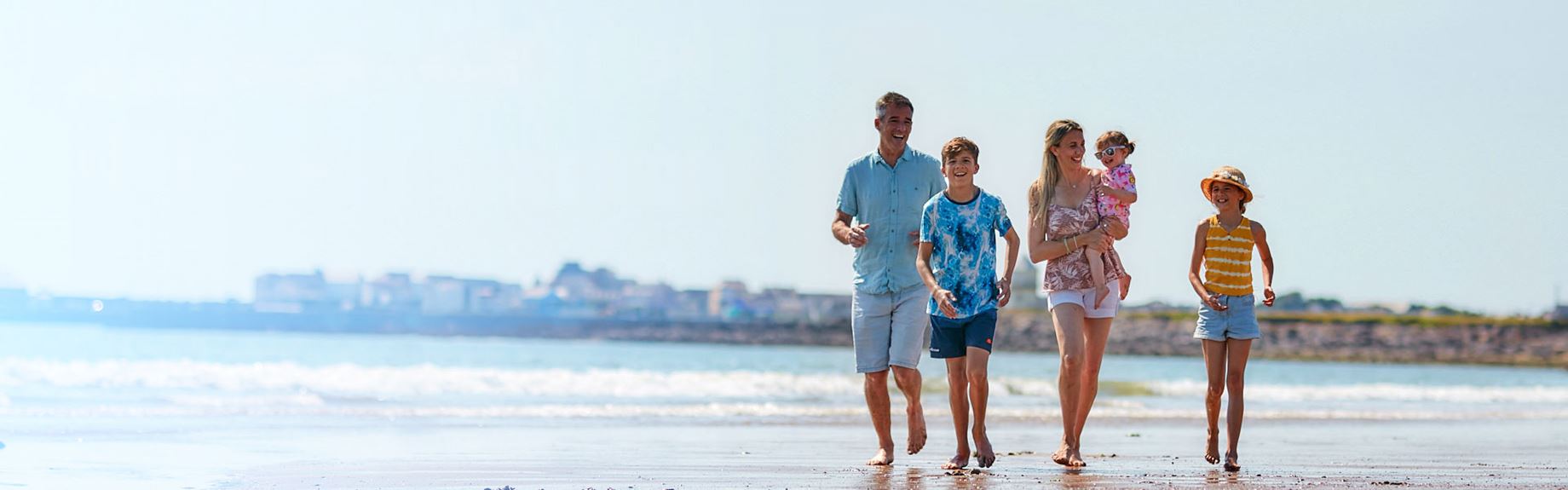 family running down beach