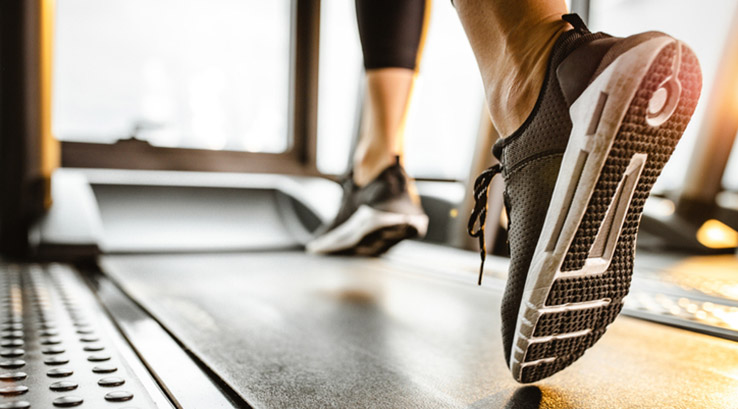 A person running on a treadmill at the gym