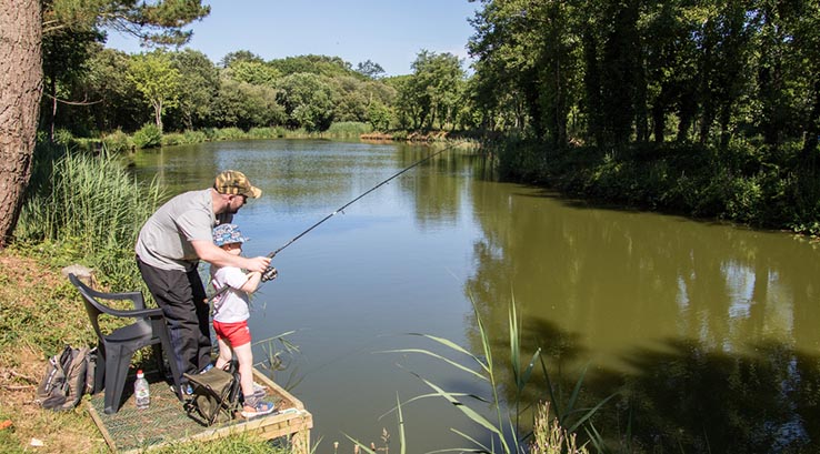 Parent and child enjoying a fishing holiday at White Acres Holiday Park