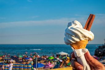 Eating ice cream on a crowded beach in summer