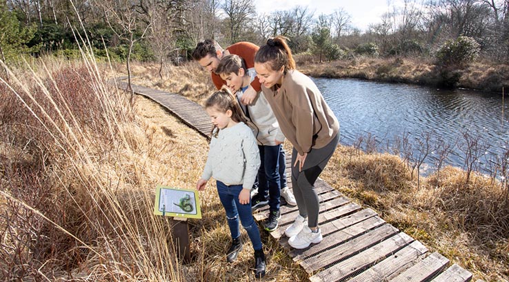 A family enjoying the wildlife nature trail at Warmwell Holiday Park