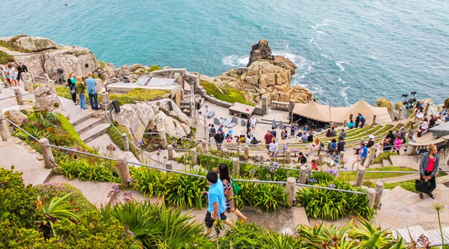 People enjoying an open air attraction by the sea in the sun