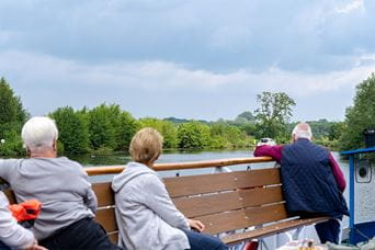 Tourists on a boat trip around the Norfolk Broads