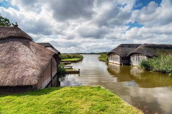 Thatched boat sheds on the Norfolk Broads