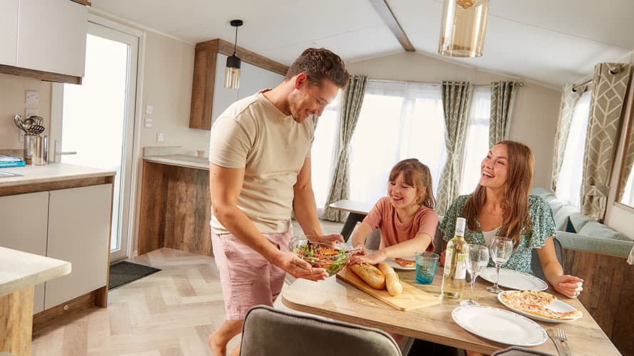 A family enjoying lunch in their caravan