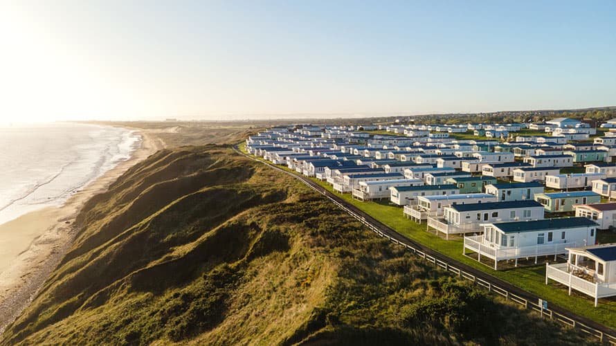 An aerial shot of a holiday park overlooking the coast