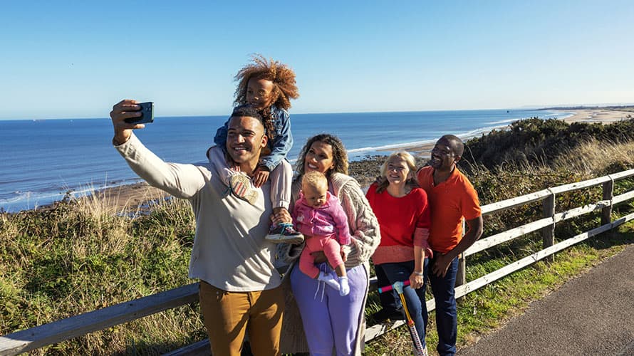 A family taking a selfie by the sea