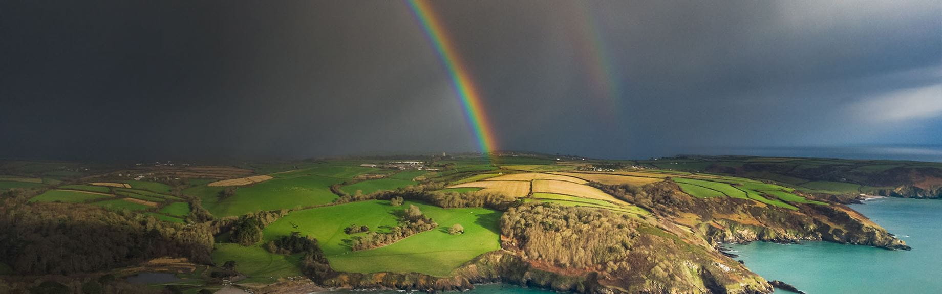 A rainbow over the coast on a stormy day