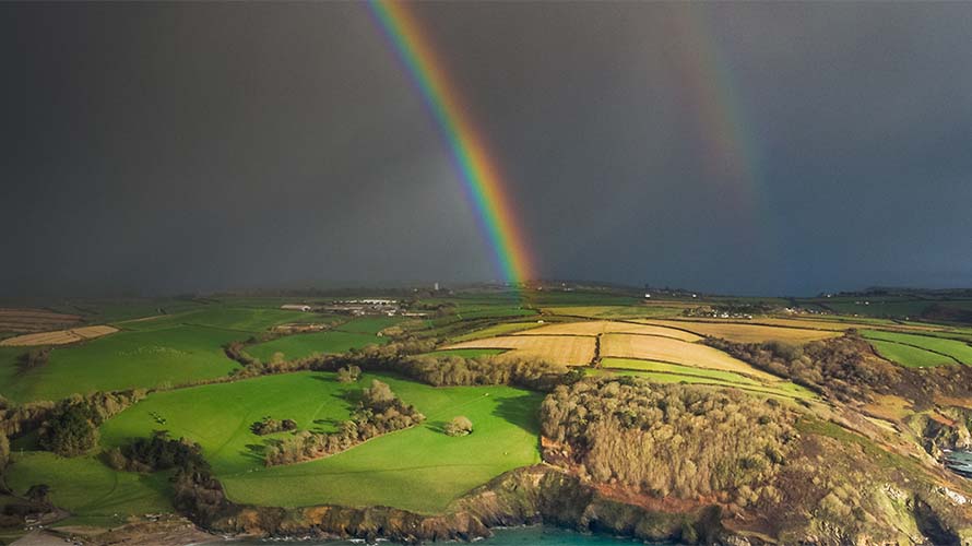 A rainbow cutting through a stormy sky