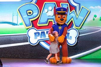 A girl on stage with a character for Paw Patrol