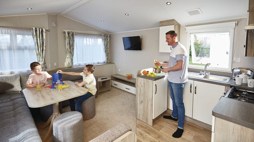 A dad cooking for his kids in a caravan