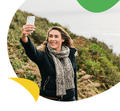 A woman talking a selfie on a walk in the countryside