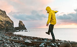 A man strolling along the beach by himself