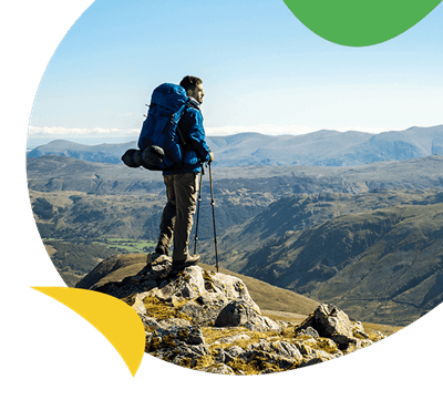 A man hiking looking over a valley