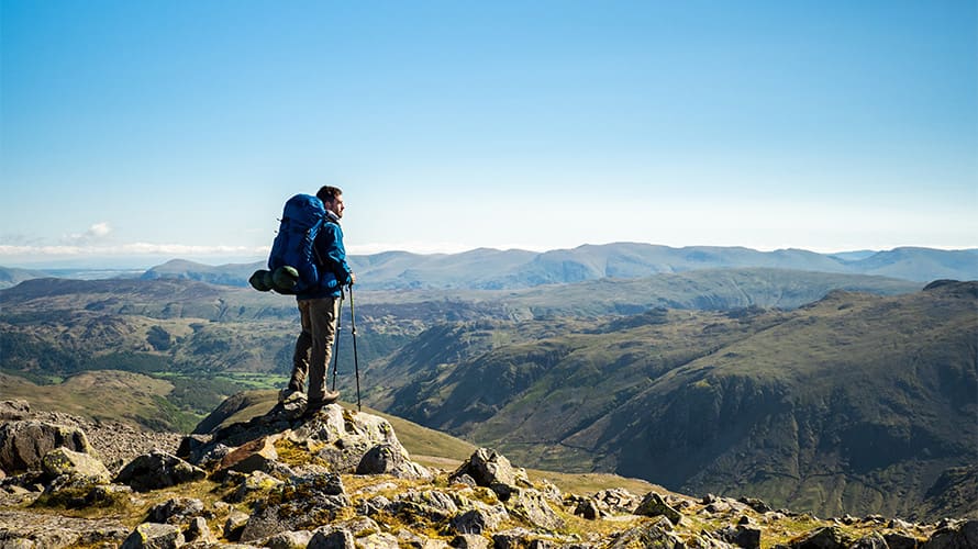 A hiker standing on top of a mountain in the UK