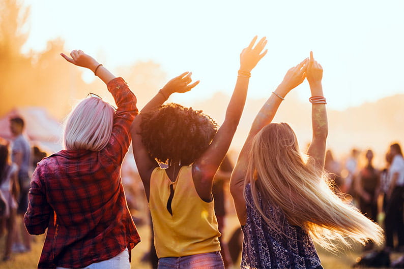 Friends dancing at a summer festival