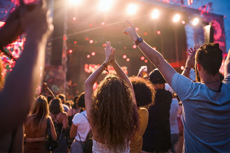 A crowd watching a performance at music festival