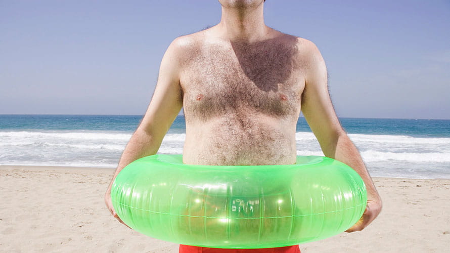 A topless man at the beach