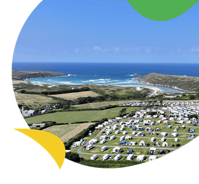 A caravan park on a hill overlooking the sea in Cornwall