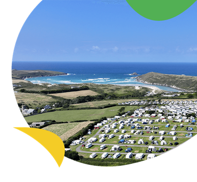 A caravan park on a hill overlooking the sea in Cornwall