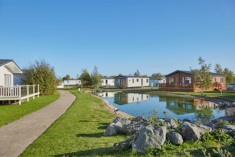 Caravans by the pond at Southview Holiday Park