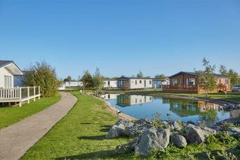 Caravans by the pond at Southview Holiday Park