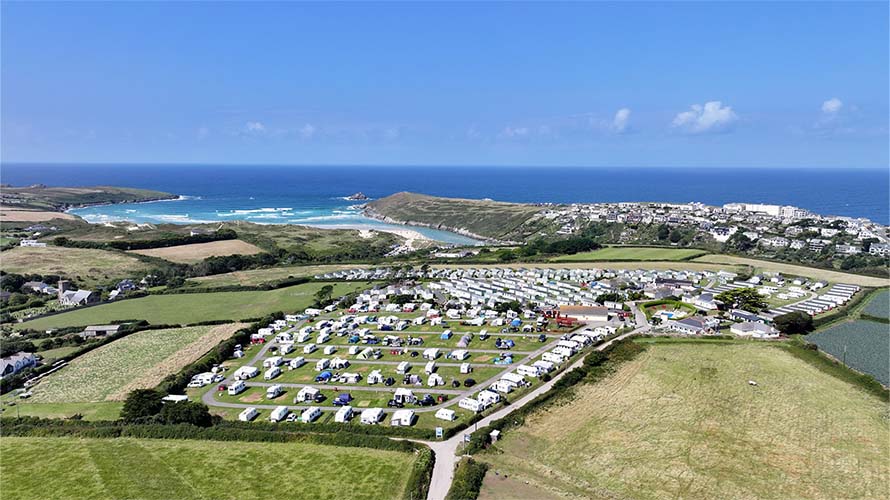 A caravan park on a hill overlooking the sea in Cornwall