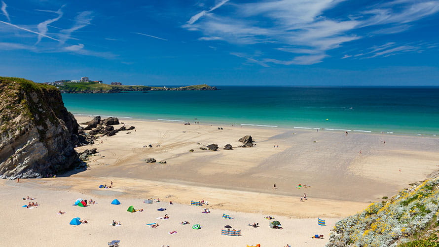 A view over the sand and water at Lusty Glaze Beach in Cornwall