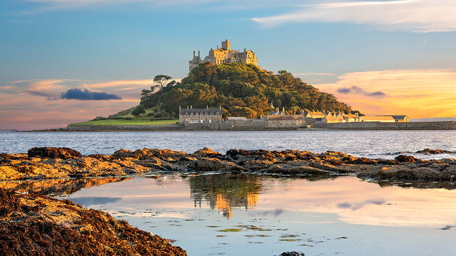 St Michaels Mount in Cornwall at sunset, showing a castle on an island hill