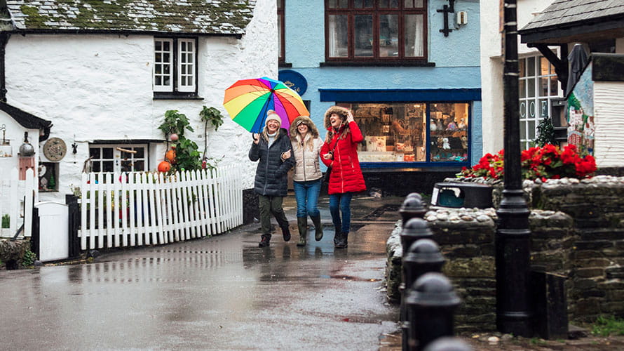 Friends shopping on a rainy day in Cornwall