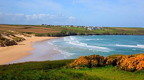 a long stretch of beautiful beach and coastline on a sunny day