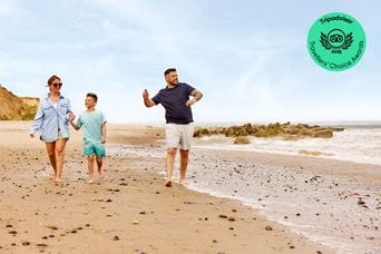 A family walking long Cayton Bay Beach