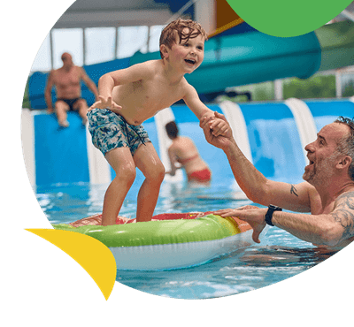 A boy standing on a float in a pool