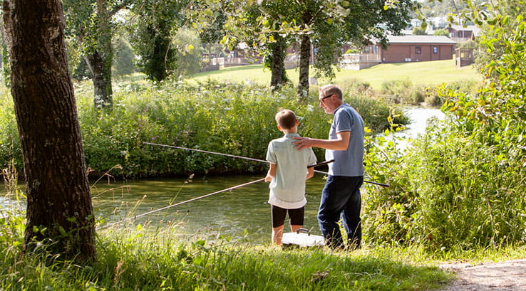 A father and son fishing on the lake at White Acres Holiday Park