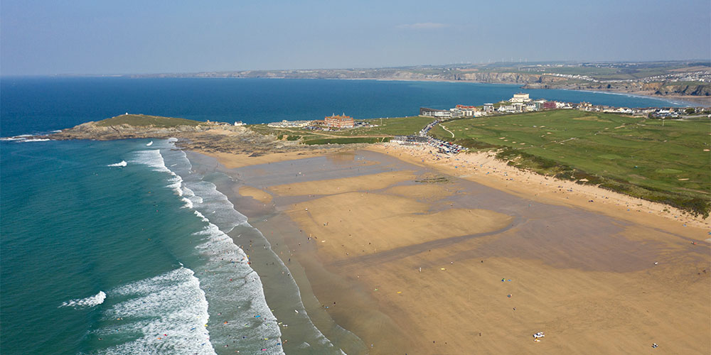 An aerial view over Fistral Beach and headland