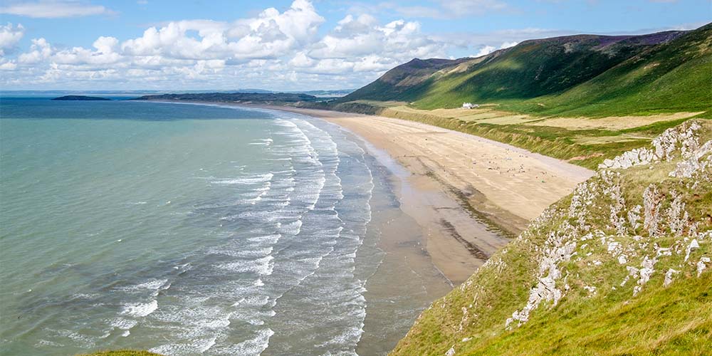 Waves rolling into Rhossili Bay in Wales